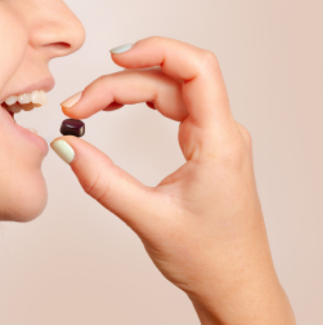 Woman enjoying tutti frutti flavored gummy supplement