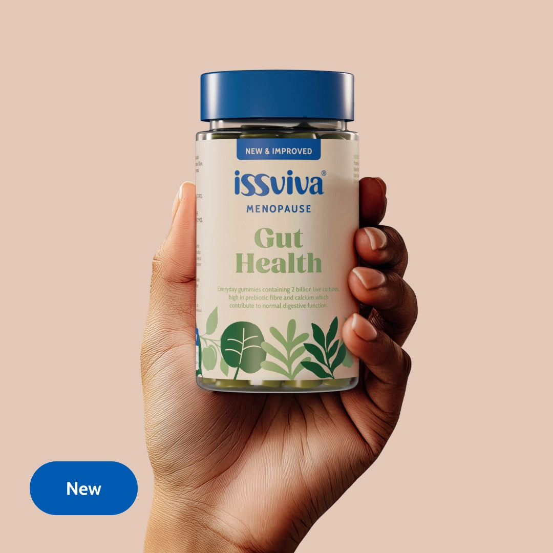 Hand holding a jar of issviva Menopause Gut Health supplement with a beige background