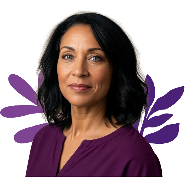 Woman wearing a beige sweater with a blue flower design on a white